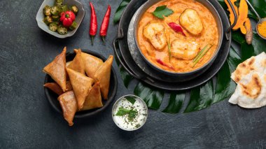 Kerala fish curry on dark background. Traditional food concept. Top view, flat lay, copy space