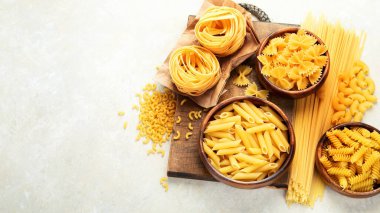 Italian pasta variety on light background. Traditional food concept. FLat lay, top view, copy space