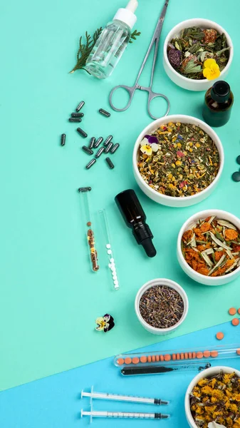 Assortment of herbal and traditional medicine on colourful background. Traditional healthcare concept. Natural homoeopathic remedies. Top view, flat lay, copy space