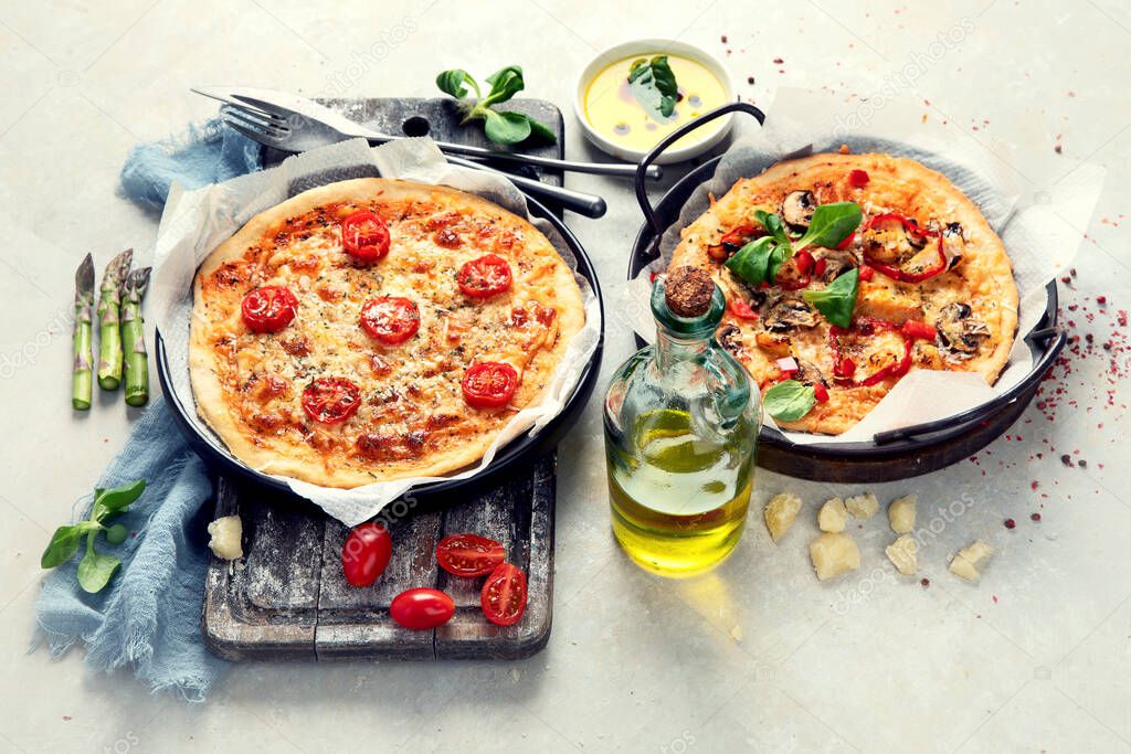 Various kinds of Italian pizza - Margherita, pepperoni, ham, mushrooms with basil, tomatoes, olive oil and cheese on white background. Top view.