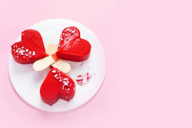 Red strawberry ice-cream on pink background. Atmospheric sweet menu concept. Top view, flat lay, copy space