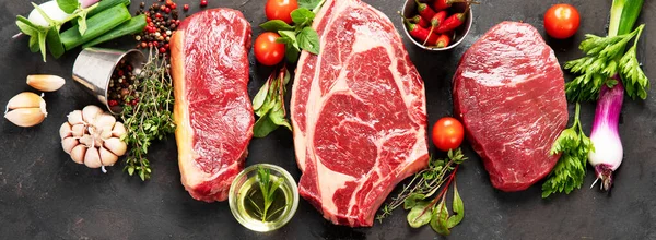 Variety Raw Beef Meat Steaks Grilling Seasoning Utensils Dark Background — стоковое фото