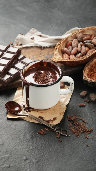 Melted chocolate drink on dark background. Hot beverage.