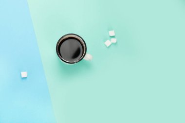 Cup of coffee on color background. Modern breakfast concept. Top view, flat lay, copy space