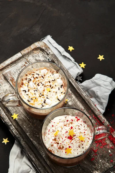 Cacao with marshmallow and cacao powder in mug. Hot beverage with whipped cream. Top view, flat lay, copy space