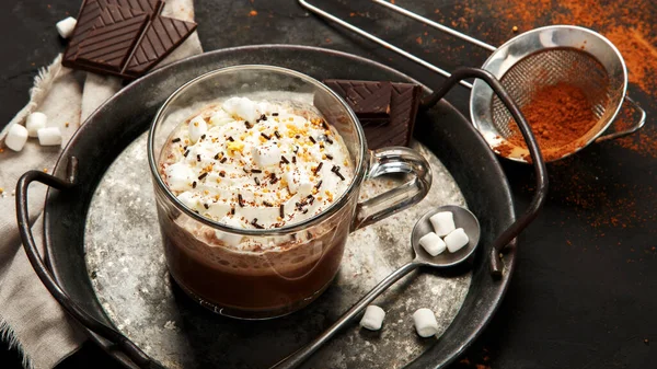 Cacao with marshmallow and cacao powder in mug. Hot beverage with whipped cream.