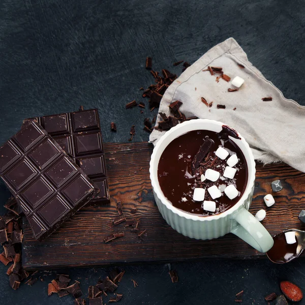 Cacao with marshmallow and cacao powder in mug. Hot beverage with whipped cream. Top view, flat lay, copy space