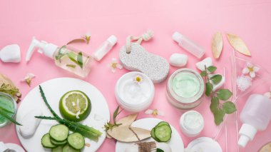 Face and body care products assortment on pink background. Natural cosmetics.  Top view, flat lay, copy space