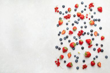 Various fresh berries on neutral background. Organic valuable food source. Top view, copy space