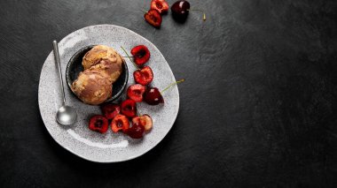 Chocolate ice cream with berries on dark background. Top view, copy space
