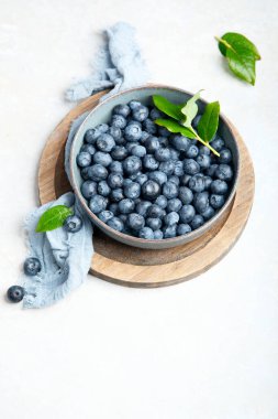 Fresh blueberry on neutral background. Vegan and vegetarian concept. Top view, copy space
