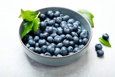 Fresh blueberry on neutral background. Vegan and vegetarian concept. Top view, copy space