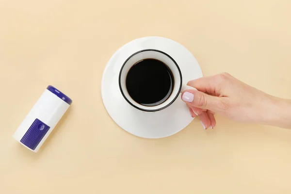 Close Woman Hand Throwing Saccharin Pills Coffee Cup White Background — Stockfoto