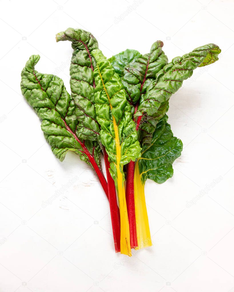 Raw chard on light background. Highly nutritious leaves. Popular component of healthy diets. Top view