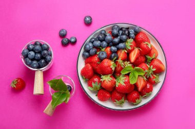 Strawberries on color background. Concept of organic food. Top view