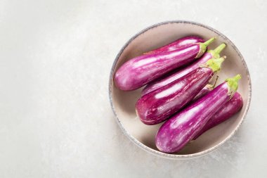 Fresh aubergine eggplant on neutral background. Popular component of healthy diets. Top view, copy spac