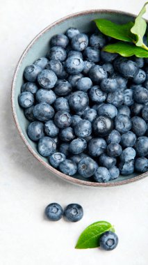 Fresh blueberry on neutral background. Vegan and vegetarian concept. Top view, copy space