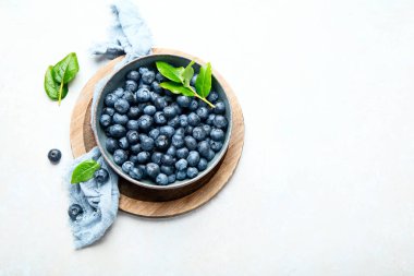 Fresh blueberry on neutral background. Vegan and vegetarian concept. Top view, copy space