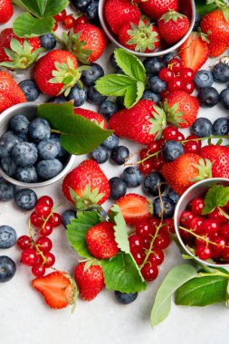 Various fresh berries on neutral background. Organic valuable food source. Top view, copy space