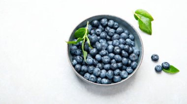 Fresh blueberry on neutral background. Vegan and vegetarian concept. Top view, copy space
