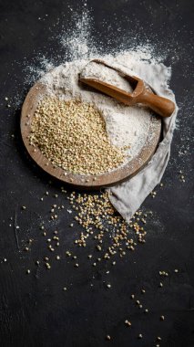 Raw green buckwheat on dark background. Food ingredients. Concept of organic food. Top view, copy space
