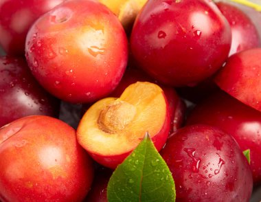 Plums in white plate on white background. Top view.