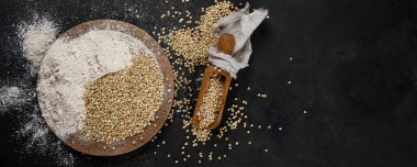 Raw green buckwheat on dark background. Food ingredients. Concept of organic food. Top view, copy space, panoramma