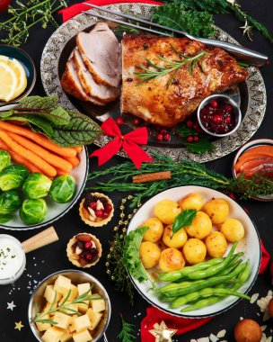 Traditional Christmas dinner on dark background. Holiday food. Top view