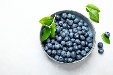 Fresh blueberry on neutral background. Vegan and vegetarian concept. Top view, copy space