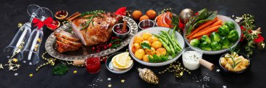 Traditional Christmas dinner on dark background. Holiday food. panorama
