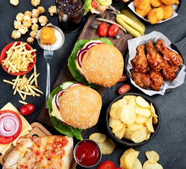 Fast food ve sağlıksız yeme konsepti. Fast food atıştırmalıkları ve kola içeceklerine yakın çekim..