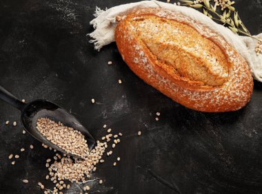 Bread assortment on dark background. Fresh homemade pastry. Top view, copy space