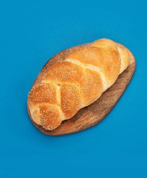 Easter sweet bread, greek tsoureki, challah on color background. Traditional food. Creative photo concept. Top view, copy space
