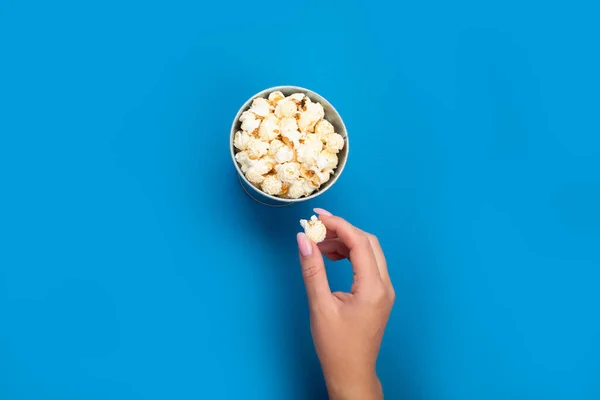 Woman Holding Popcorn Blue Background Top View — Stock Photo, Image