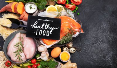 Karanlık arka planda sağlıklı yiyecek seçimi. Detoks ve temiz diyet konsepti. Yüksek miktarda vitamin, mineral ve antioksidan içeren yiyecekler. Yaş karşıtı yiyecekler. Üst görünüm.