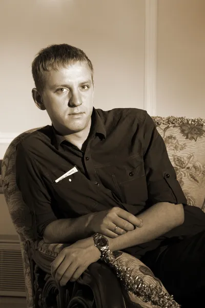 Young man in chair — Stock Photo, Image