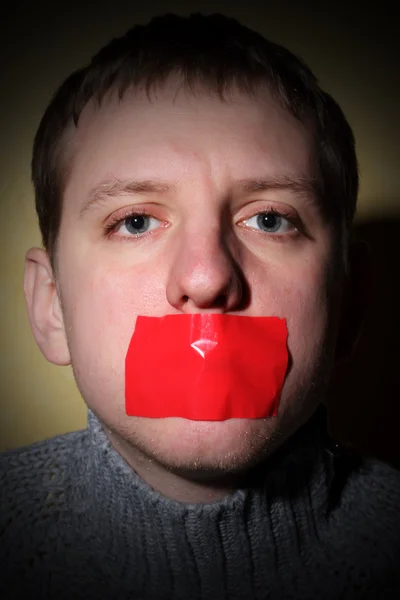 Man closes his mouth red tape — Stock Photo, Image