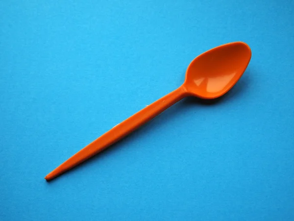 Orange pastic spoons — Stock Photo, Image