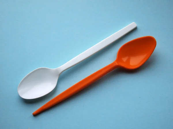 Orange and white pastic spoons — Stock Photo, Image