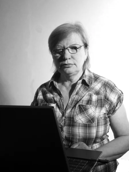 Middle age woman with her laptop computer — Stok fotoğraf