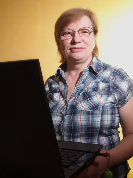 Middle age woman with her laptop computer — Stok fotoğraf