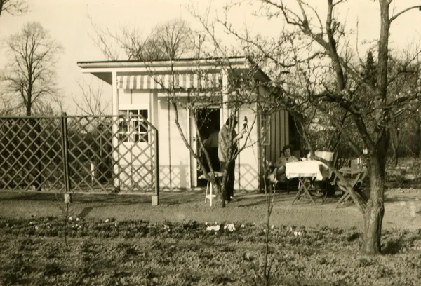 Woman standing near the garden house — Stock Photo, Image