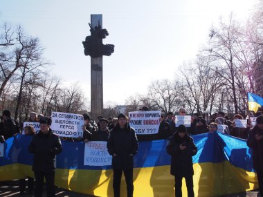 UKRAINE, LUGANSK - March 1, 2014: Euromaidan activists evaluate events in the Crimea clearly this is the occupation of the country by Russian military forces. They took to the center of Lugansk, demanding from Vladimir Putin to stop the intervention clipart