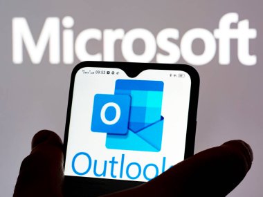 Kiev, Ukraine - January 9, 2022:  In this photo illustration Microsoft Outlook logo seen displayed on a smartphone
