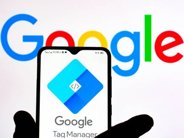 Kiev, Ukraine - January 12, 2022: In this photo illustration, the Google Tag Manager logo is seen displayed on a smartphone screen and Google logo in the background. 