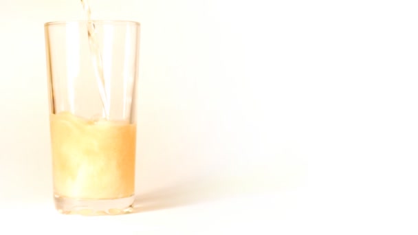 Beer is poured into a glass on white background — Stock Video