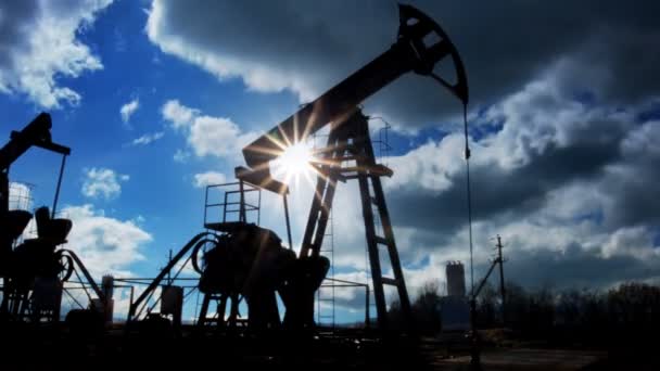 Working oil pumps silhouette against timelapse clouds — Stock Video