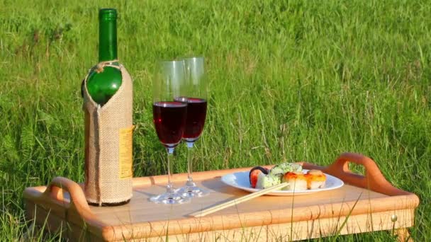 Picnic - tabe with wine and japanese food — Stock Video