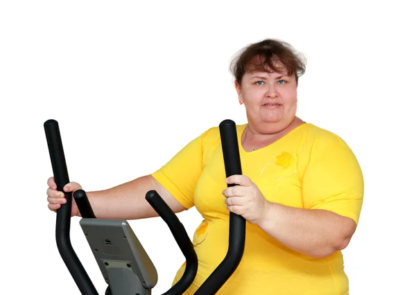 Overweight woman exercising on trainer — Stock Photo, Image