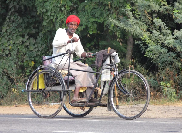 Old indian man on bike with manual drive — Stock Photo, Image